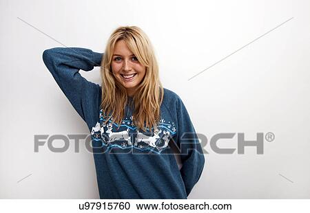 Portrait of happy woman in sweater against white background View Large Photo Image Stock Image - Portrait of happy woman in sweater against white background. Fotosearch