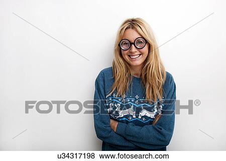 Stock Photo - Portrait of happy woman wearing eyeglasses against white background. Fotosearch
