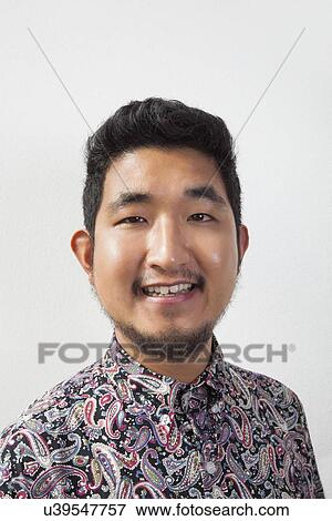 Portrait of happy young man against white background View Large Photo Image Stock Photo - Portrait of happy young man against white background. Fotosearch