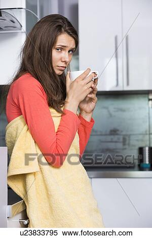 Portrait of ill woman having coffee in kitchen View Large Photo Image Stock Photography - Portrait of ill woman having coffee in kitchen. Fotosearch