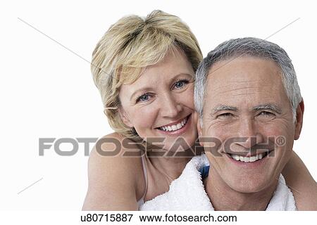 Stock Photo - Portrait of loving couple smiling over white background. Fotosearch