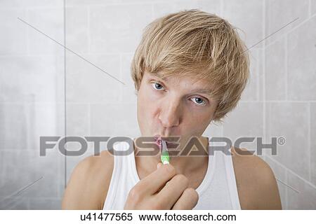 Portrait of man brushing teeth in bathroom View Large Photo Image Stock Photography - Portrait of man brushing teeth in bathroom. Fotosearch
