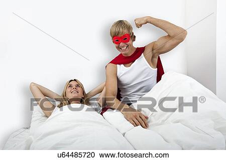 Portrait of man in superhero costume with woman on bed View Large Photo Image Stock Image - Portrait of man in superhero costume with woman on bed. Fotosearch