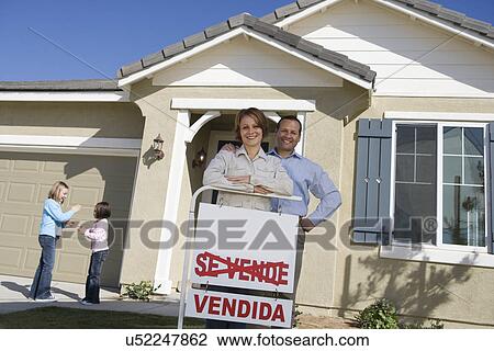 Portrait of mid-adult couple in front of new house children (6-9) in background View Large Photo Image Stock Image - Portrait of mid-adult couple in front of new house children (6-9) in background. Fotosearch