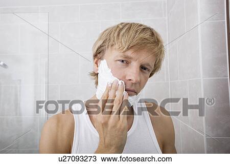 Portrait of mid-adult man applying shaving cream in bathroom View Large Photo Image Stock Image - Portrait of mid-adult man applying shaving cream in bathroom. Fotosearch