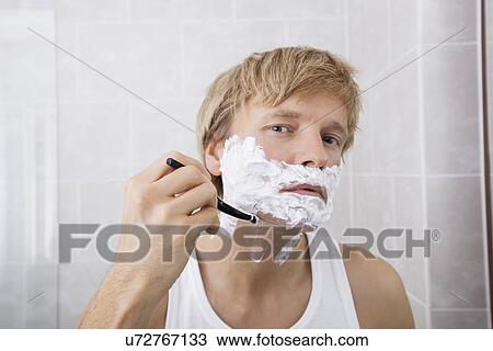 Portrait of mid-adult man shaving in bathroom View Large Photo Image Stock Image - Portrait of mid-adult man shaving in bathroom. Fotosearch