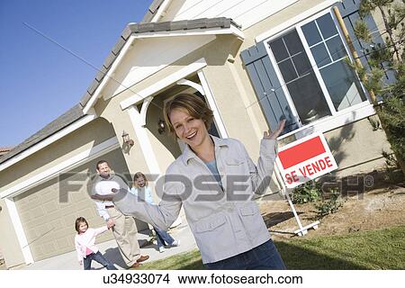 Portrait of mid-adult woman in front of new house View Large Photo Image Picture - Portrait of mid-adult woman in front of new house. Fotosearch