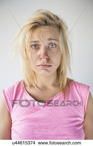 Portrait of sad woman suffering from cold against gray background View Large Photo Image Picture - Portrait of sad woman suffering from cold against gray background. Fotosearch
