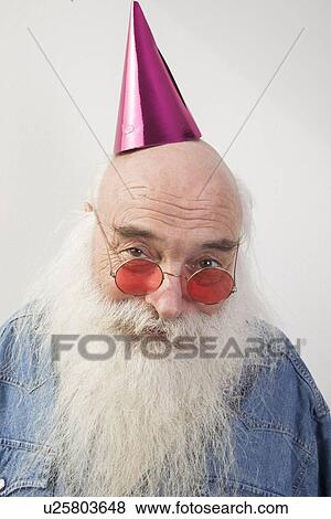 Portrait of senior man wearing red glasses and party hat over gray background View Large Photo Image Stock Photo - Portrait of senior man wearing red glasses and party hat over gray background. Fotosearch