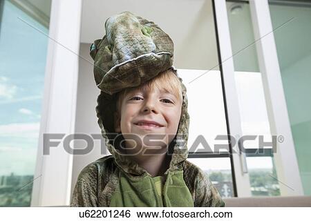 Portrait of smiling boy in dinosaur costume at home View Large Photo Image Stock Photograph - Portrait of smiling boy in dinosaur costume at home. Fotosearch