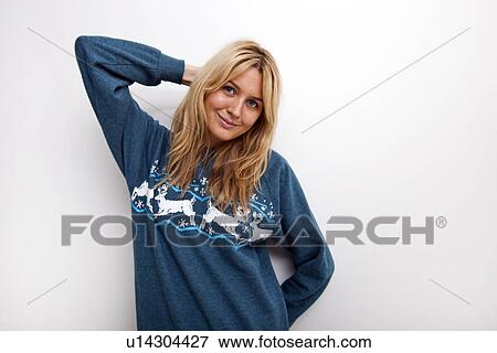 Portrait of smiling woman in sweater against white background View Large Photo Image Stock Photo - Portrait of smiling woman in sweater against white background. Fotosearch