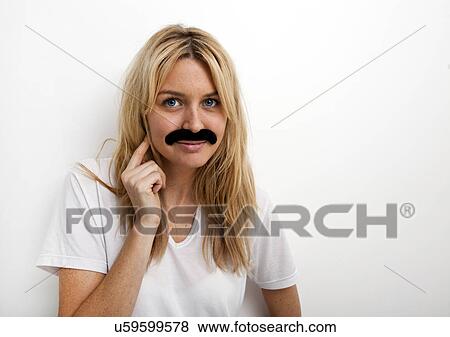 Portrait of woman in fake mustache against white background View Large Photo Image Stock Photo - Portrait of woman in fake mustache against white background. Fotosearch