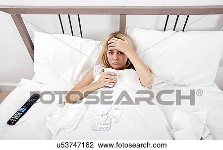 Portrait of woman suffering from cold having coffee in bed View Large Photo Image Stock Image - Portrait of woman suffering from cold having coffee in bed. Fotosearch