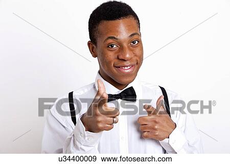 Stock Photo - Portrait of young man pointing over white background. Fotosearch