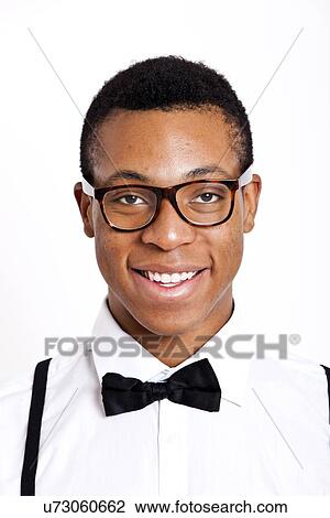 Portrait of young man wearing glasses over white background View Large Photo Image Stock Image - Portrait of young man wearing glasses over white background. Fotosearch