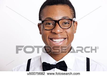 Portrait of young man wearing eyeglasses against white background View Large Photo Image Stock Image - Portrait of young man wearing eyeglasses against white background. Fotosearch