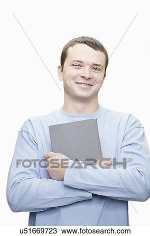 Portrait of young man with book against white background View Large Photo Image Stock Image - Portrait of young man with book against white background. Fotosearch