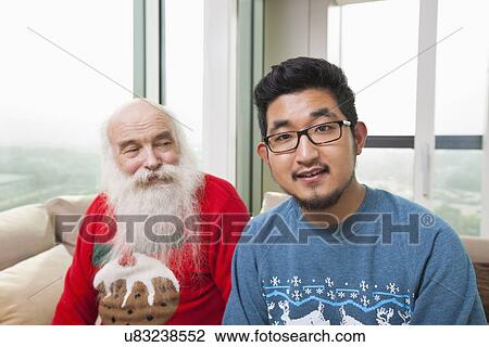Portrait of young man with grandfather looking at him View Large Photo Image Stock Image - Portrait of young man with grandfather looking at him. Fotosearch