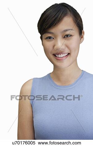 Stock Photography - Portrait of young woman smiling against white background. Fotosearch