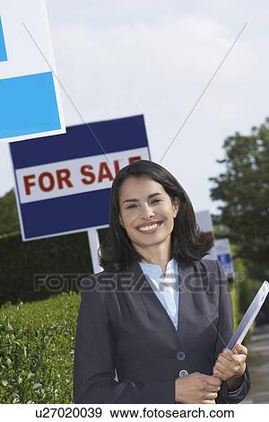 Real estate agent near for sale signs portrait View Large Photo Image Stock Photo - Real estate agent near for sale signs portrait. Fotosearch
