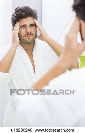 Reflection of man in bathrobe suffering from headache View Large Photo Image Stock Image - Reflection of man in bathrobe suffering from headache. Fotosearch