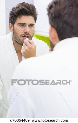 Reflection of man taking medicine at home View Large Photo Image Stock Photo - Reflection of man taking medicine at home. Fotosearch