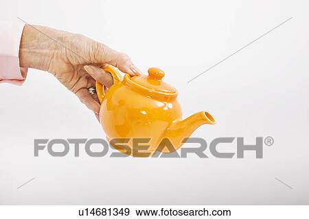 Senior businesswoman's hand holding teakettle over white background View Large Photo Image Stock Photo - Senior businesswoman's hand holding teakettle over white background. Fotosearch