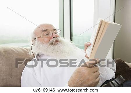 Senior man reading book in house View Large Photo Image Stock Photograph - Senior man reading book in house. Fotosearch