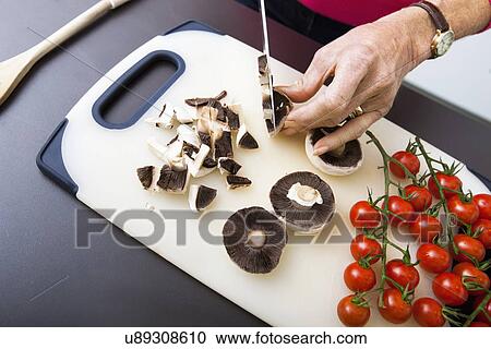 Senior woman's hand chopping mushrooms on cutting board View Large Photo Image Stock Image - Senior woman's hand chopping mushrooms on cutting board. Fotosearch