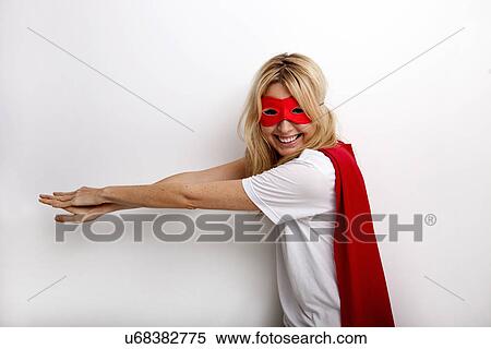 Side view portrait of happy woman in superhero costume against white background View Large Photo Image Stock Photography - Side view portrait of happy woman in superhero costume against white background. Fotosearch