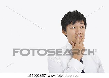 Thoughtful mid adult businessman over white background View Large Photo Image Stock Photo - Thoughtful mid adult businessman over white background. Fotosearch