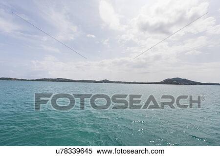 Tropical blue sea with island in background, Koh Samui, Thailand View Large Photo Image Stock Photography - Tropical blue sea with island in background, Koh Samui, Thailand. Fotosearch