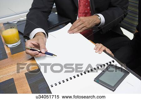 Stock Photography - Two business people at business meeting. Fotosearch
