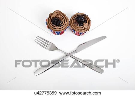 Union Jack chocolate cupcakes with fork and knife against white background View Large Photo Image Stock Photo - Union Jack chocolate cupcakes with fork and knife against white background. Fotosearch