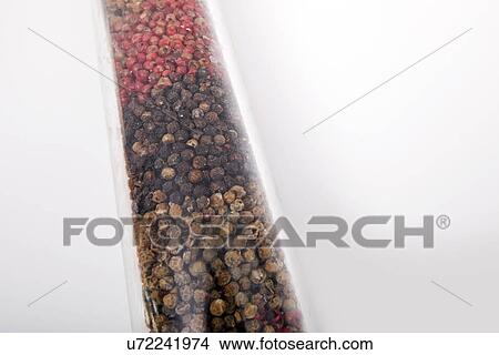 Picture - Various peppercorns in package against white background. Fotosearch