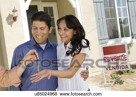 Young couple buying house taking keys View Large Photo Image Stock Photo - Young couple buying house taking keys. Fotosearch