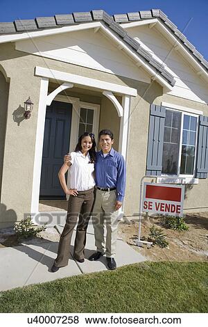 Young couple in front of new house View Large Photo Image Stock Photo - Young couple in front of new house. Fotosearch