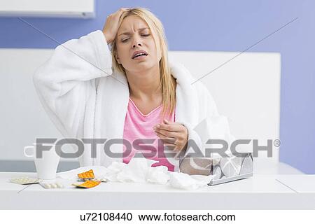 Young exhausted woman suffering from headache and cold in kitchen View Large Photo Image Stock Image - Young exhausted woman suffering from headache and cold in kitchen. Fotosearch