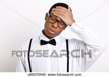 Young man suffering from headache over white background View Large Photo Image Stock Image - Young man suffering from headache over white background. Fotosearch