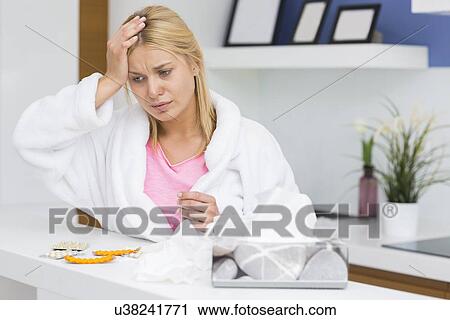 Young woman suffering from cold in kitchen View Large Photo Image Stock Image - Young woman suffering from cold in kitchen. Fotosearch