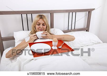 Young woman with breakfast tray in bed View Large Photo Image Stock Photography - Young woman with breakfast tray in bed. Fotosearch