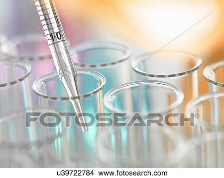Picture - A graduated pipette being inserted into test tube. Fotosearch