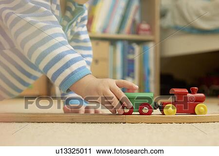 Baby boy playing with train set View Large Photo Image Stock Image - Baby boy playing with train set. Fotosearch