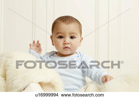 Baby sitting on sheepskin rug View Large Photo Image Picture - Baby sitting on sheepskin rug. Fotosearch