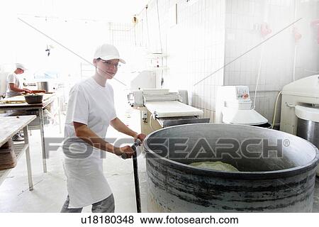 Stock Photo - Baker operating mixer. Fotosearch