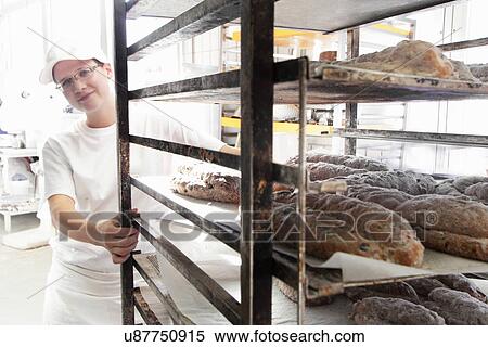 Baker pulling trolley of bread View Large Photo Image Stock Photography - Baker pulling trolley of bread. Fotosearch