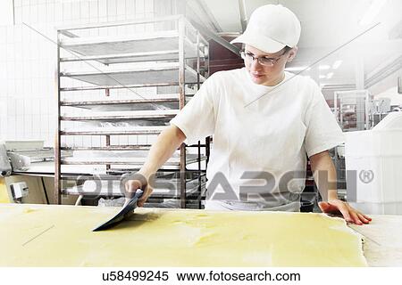 Baker spreading dough View Large Photo Image Stock Photography - Baker spreading dough. Fotosearch
