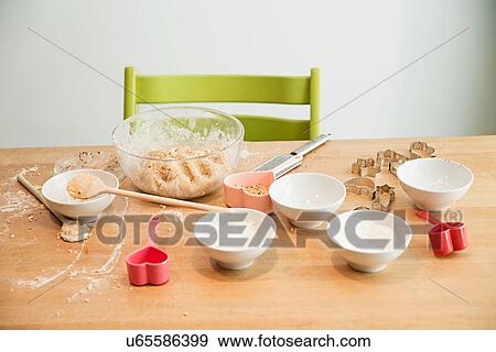 Stock Photo - Batter in mixing bowl, ladle, baking mold. Fotosearch