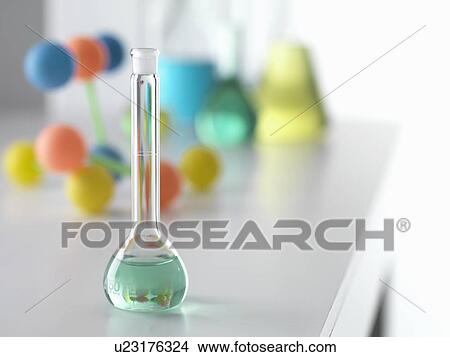 Picture - Beaker containing solution from chemical experiment with molecular model in background on lab bench. Fotosearch