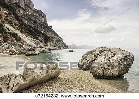 Boulders on beach, Cala Goloritze, Sardinia, Italy View Large Photo Image Stock Image - Boulders on beach, Cala Goloritze, Sardinia, Italy. Fotosearch